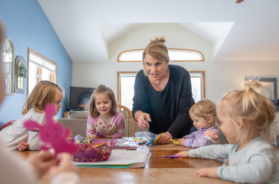 Provider working with kids at table